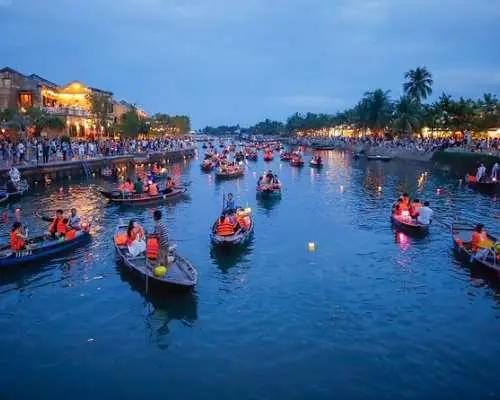 Travelers on a lantern river boat in Hoi An